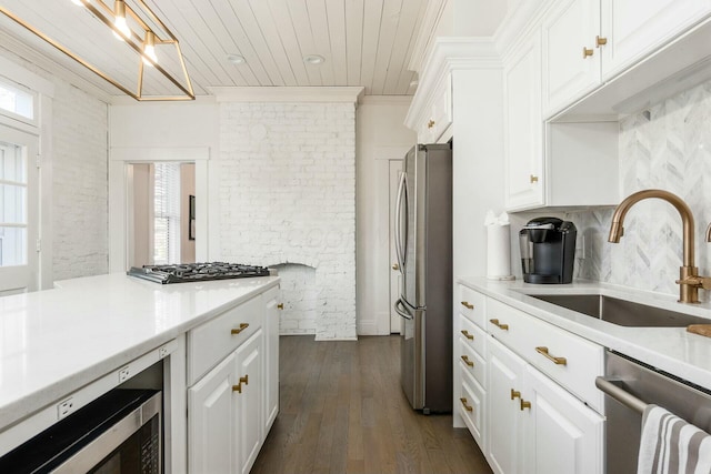 kitchen featuring sink, white cabinets, dark wood-type flooring, and appliances with stainless steel finishes