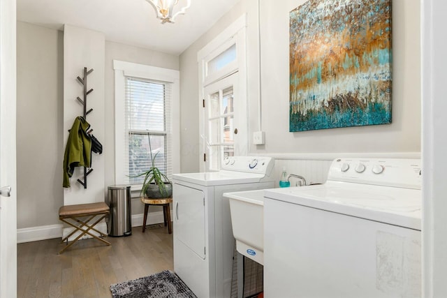 clothes washing area with independent washer and dryer and light hardwood / wood-style flooring