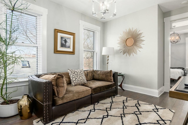 living room with hardwood / wood-style flooring and an inviting chandelier