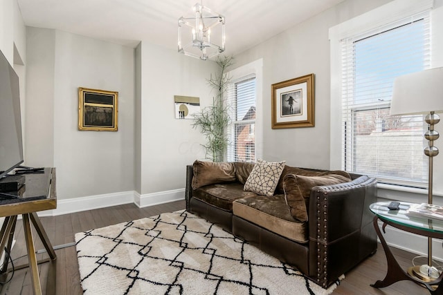 living room with a chandelier, hardwood / wood-style floors, and a wealth of natural light