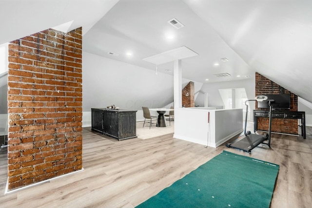 interior space featuring light hardwood / wood-style floors and vaulted ceiling