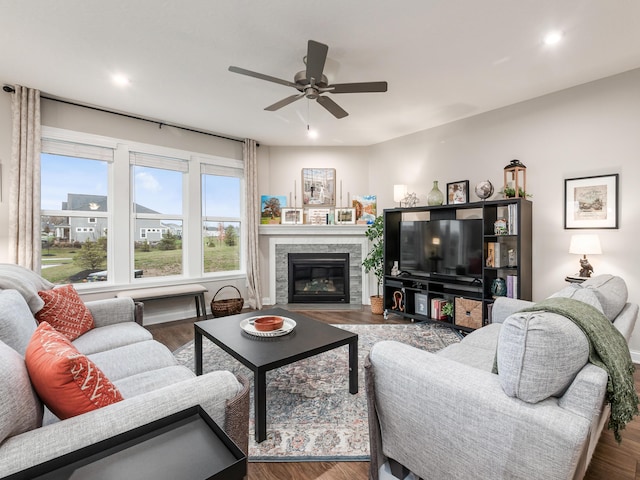 living room featuring a fireplace, hardwood / wood-style flooring, and ceiling fan