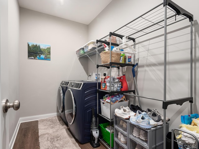 clothes washing area featuring hardwood / wood-style flooring and washer and dryer