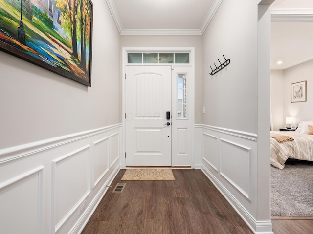 entryway with dark hardwood / wood-style floors and crown molding