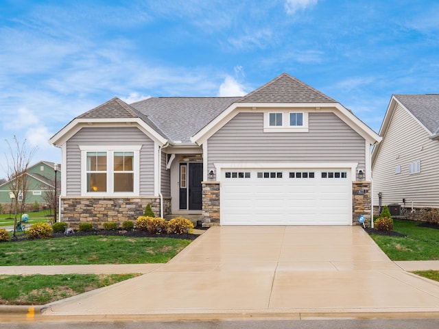 craftsman-style home with cooling unit, a front lawn, and a garage