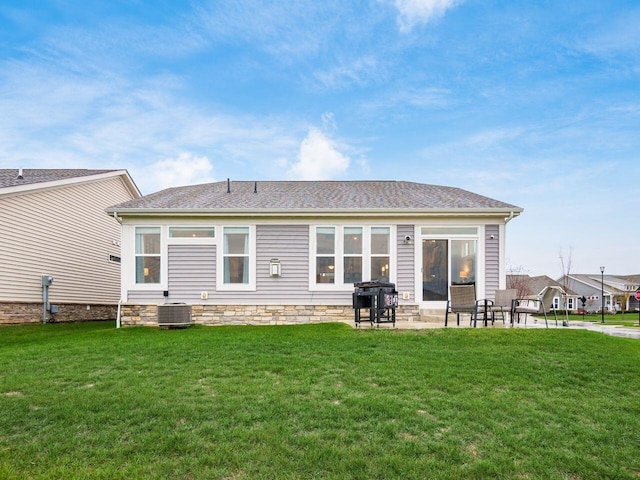 back of property with a yard, central AC, and a patio area