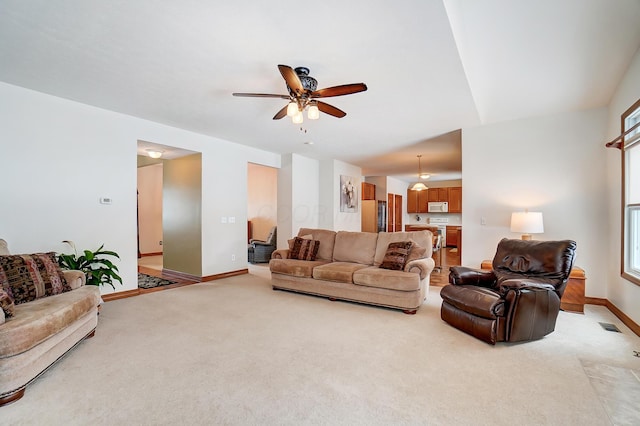 carpeted living room with ceiling fan and a wealth of natural light