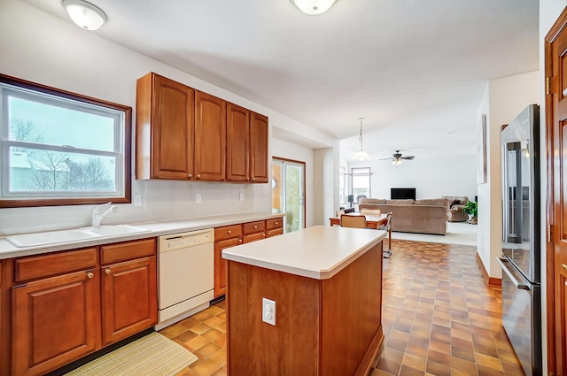 kitchen featuring ceiling fan, a center island, sink, white dishwasher, and high quality fridge