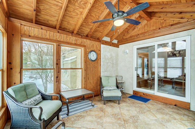 sunroom / solarium with vaulted ceiling with beams, ceiling fan, and wood ceiling