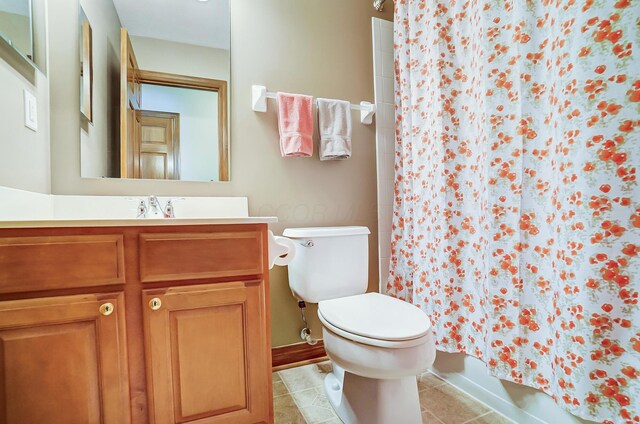 bathroom with tile patterned floors, vanity, and toilet