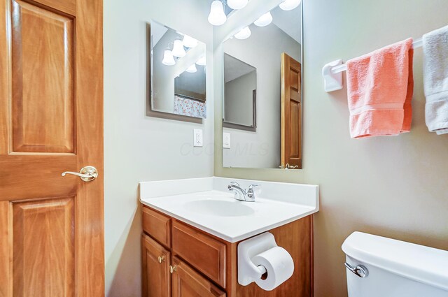 bathroom featuring vanity and toilet