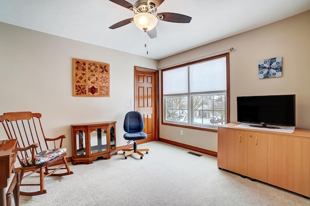 sitting room with ceiling fan and light colored carpet