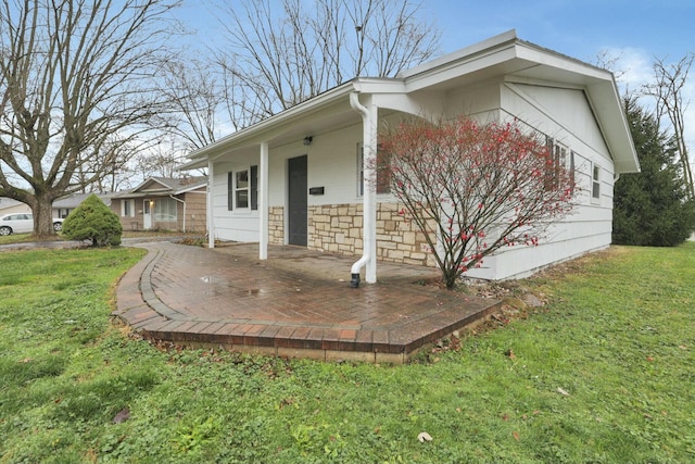 exterior space featuring a front lawn and a porch