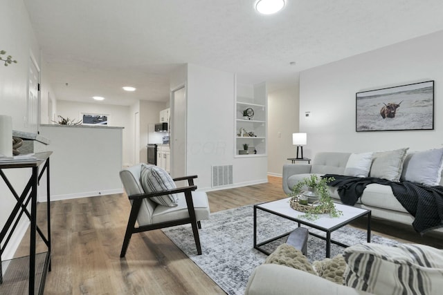 living room featuring a textured ceiling and hardwood / wood-style flooring