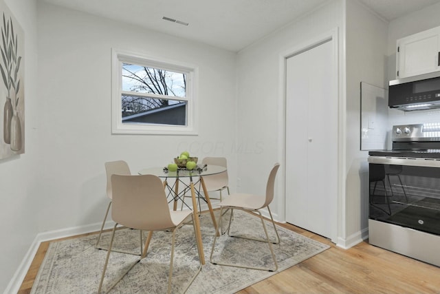 dining space with light hardwood / wood-style floors