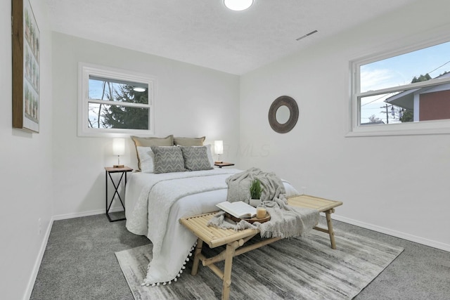 bedroom with multiple windows and carpet floors