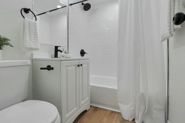 full bathroom with shower / bath combo with shower curtain, toilet, wood-type flooring, and vanity