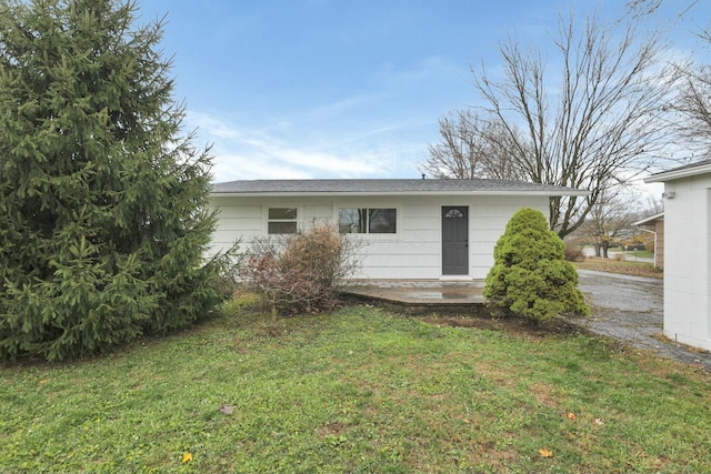 rear view of property with a lawn