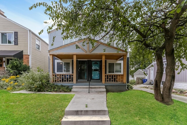 view of front of house featuring covered porch and a front yard