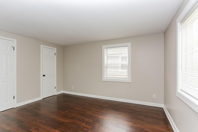 unfurnished bedroom featuring dark wood-type flooring