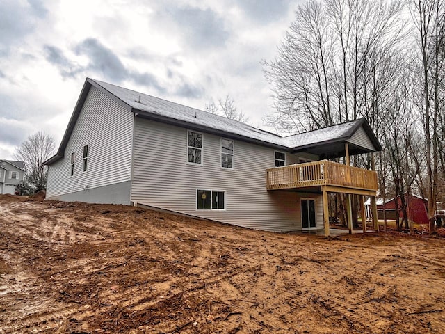 back of property with a wooden deck