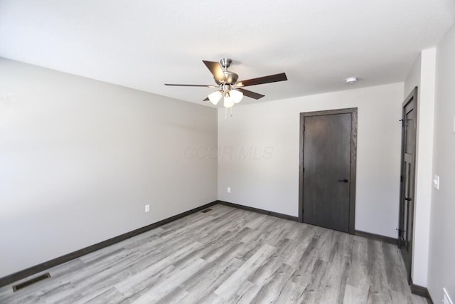 unfurnished bedroom featuring ceiling fan, light hardwood / wood-style flooring, and a closet