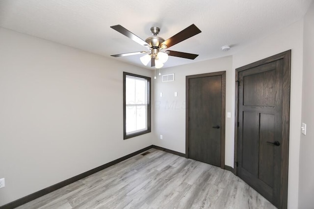 unfurnished bedroom with ceiling fan and light hardwood / wood-style floors