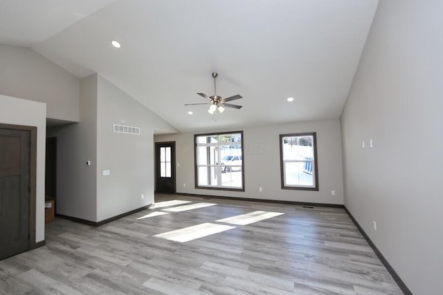 spare room with light hardwood / wood-style flooring, ceiling fan, and lofted ceiling