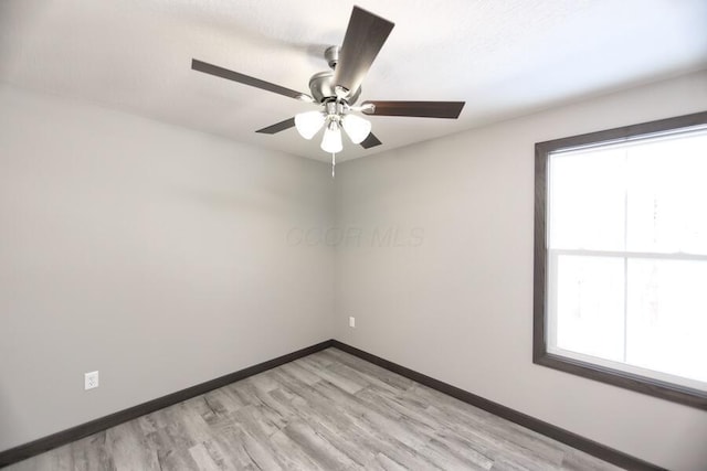 spare room with light wood-type flooring and ceiling fan