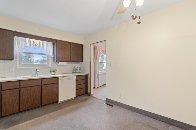 kitchen featuring backsplash, dishwasher, plenty of natural light, and sink