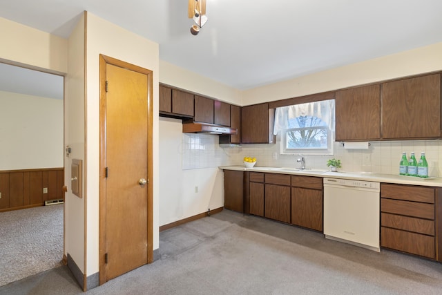 kitchen featuring dishwasher, sink, backsplash, and light carpet