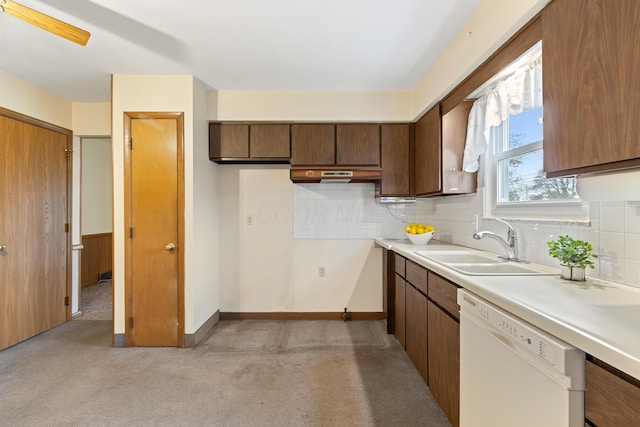 kitchen with dishwasher, light carpet, backsplash, and sink