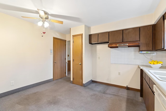 kitchen featuring decorative backsplash, light carpet, white dishwasher, ceiling fan, and sink