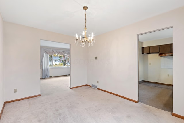 unfurnished dining area featuring light carpet and an inviting chandelier