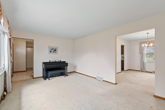 unfurnished room featuring carpet and an inviting chandelier