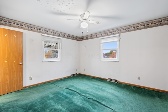 empty room featuring carpet flooring, ceiling fan, and a healthy amount of sunlight