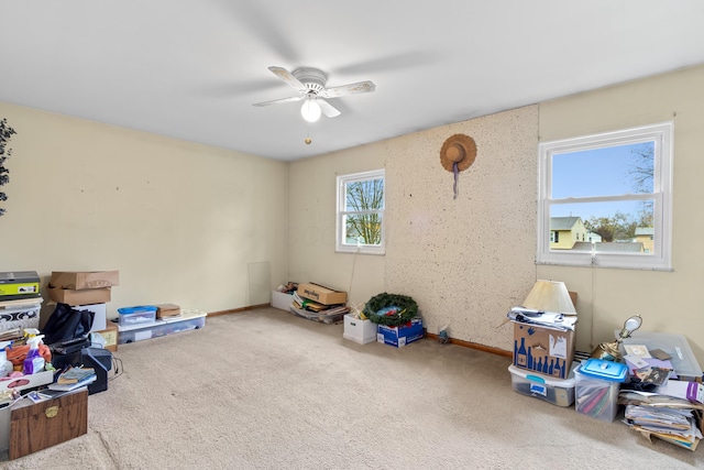 interior space featuring ceiling fan and carpet floors