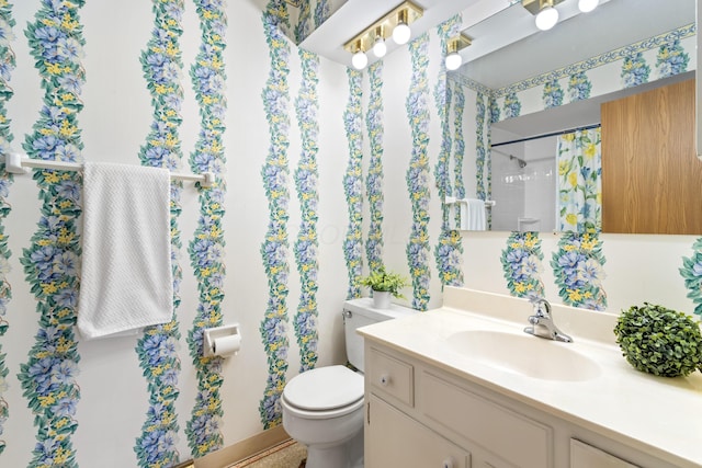 bathroom featuring a shower with shower curtain, vanity, and toilet