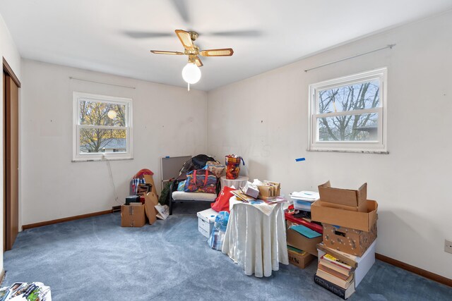 recreation room with carpet flooring, ceiling fan, and a healthy amount of sunlight