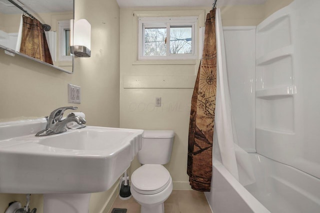 full bathroom with tile patterned floors, toilet, sink, and shower / tub combo with curtain