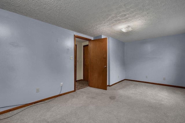 unfurnished room with light carpet and a textured ceiling