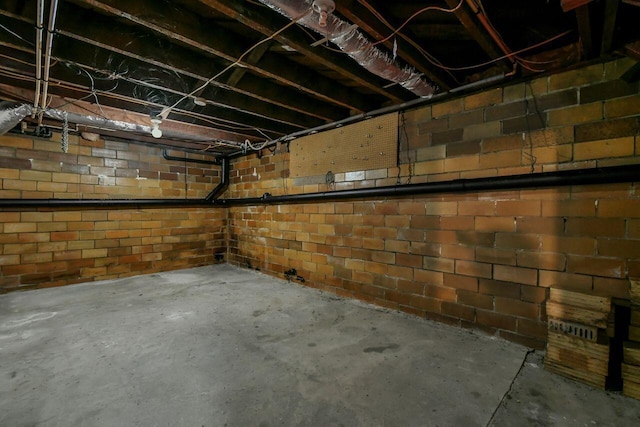 basement with brick wall