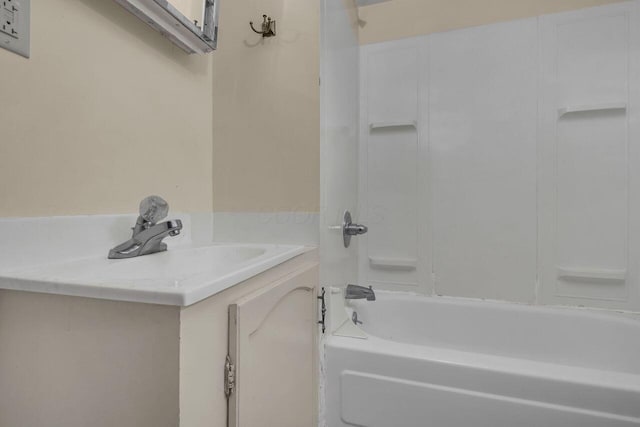 bathroom featuring vanity and  shower combination