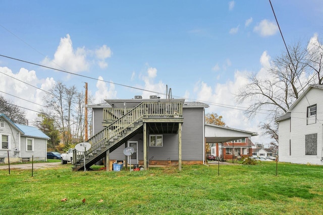 rear view of property with a lawn and a wooden deck