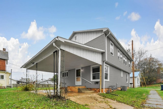 exterior space with a front lawn and central AC unit