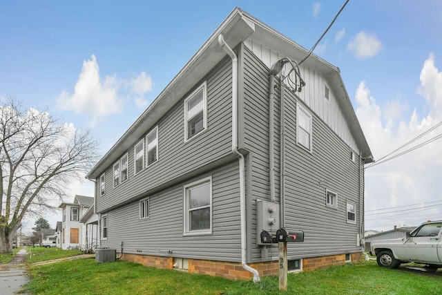 view of home's exterior with a yard and cooling unit