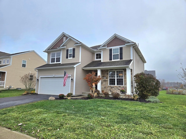 view of front of property featuring a front yard and a garage