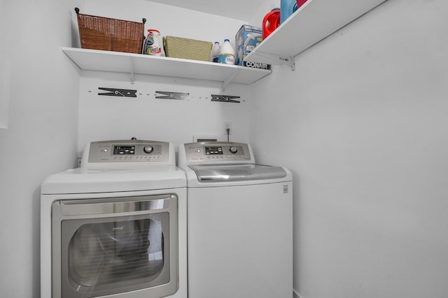 laundry room with washing machine and clothes dryer