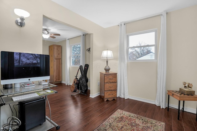 office space with plenty of natural light, ceiling fan, and dark wood-type flooring