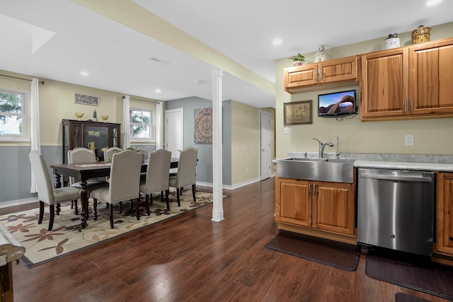 kitchen featuring dishwasher, sink, dark wood-type flooring, and a wealth of natural light